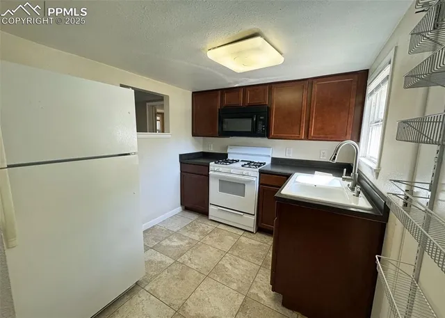 a kitchen with a refrigerator sink and a stove