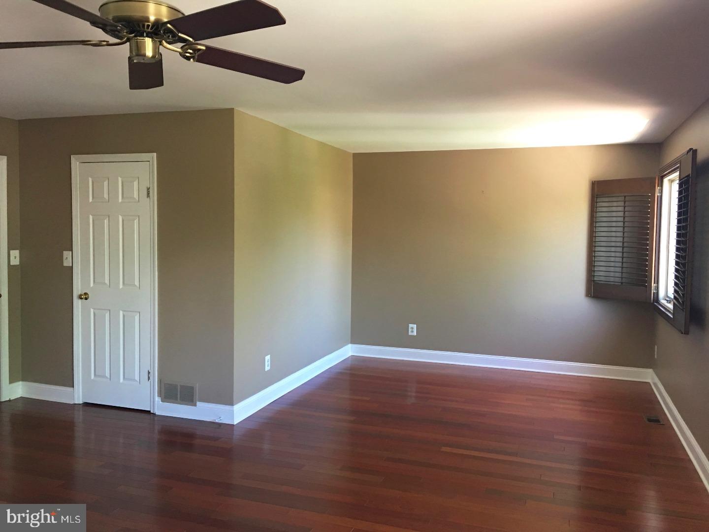 19 Hanover Court Princeton, NJ 08540 - Photo 11 of 25 a view of an empty room with wooden floor and a ceiling fan