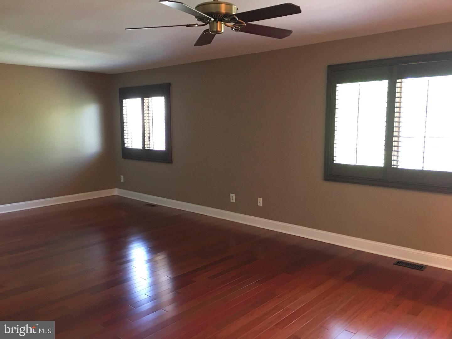 19 Hanover Court Princeton, NJ 08540 - Photo 13 of 25 a view of an empty room with wooden floor and a window
