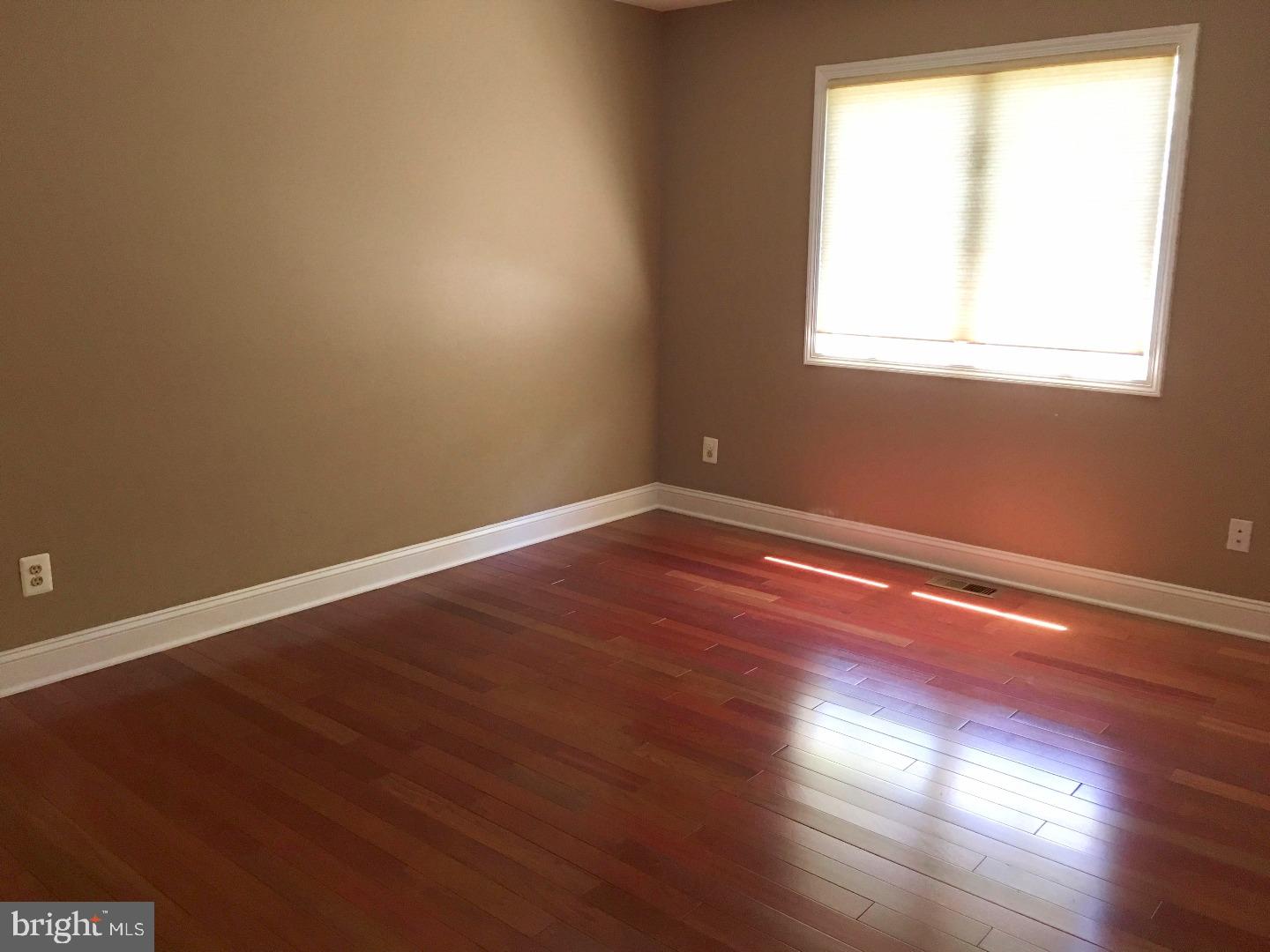 19 Hanover Court Princeton, NJ 08540 - Photo 17 of 25 an empty room with wooden floor and windows