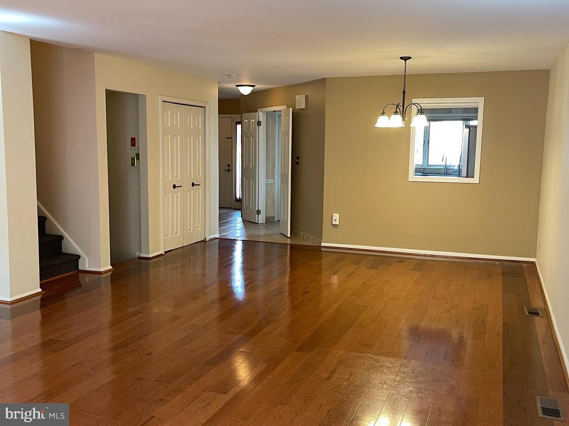19 Hanover Court Princeton, NJ 08540 - Photo 2 of 25 a view of an empty room with wooden floor and a window