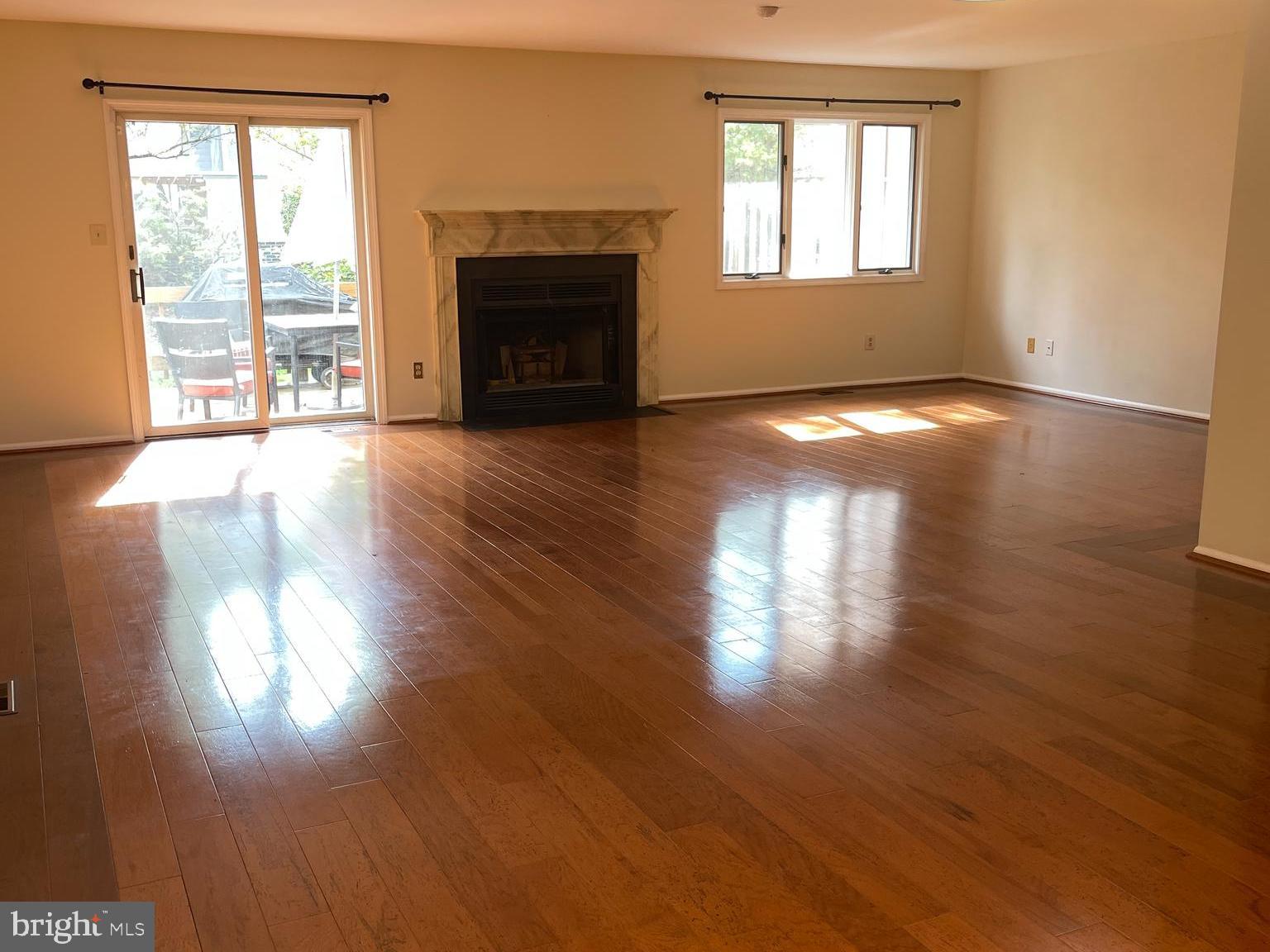 19 Hanover Court Princeton, NJ 08540 - Photo 4 of 25 a view of empty room with wooden floor and fireplace