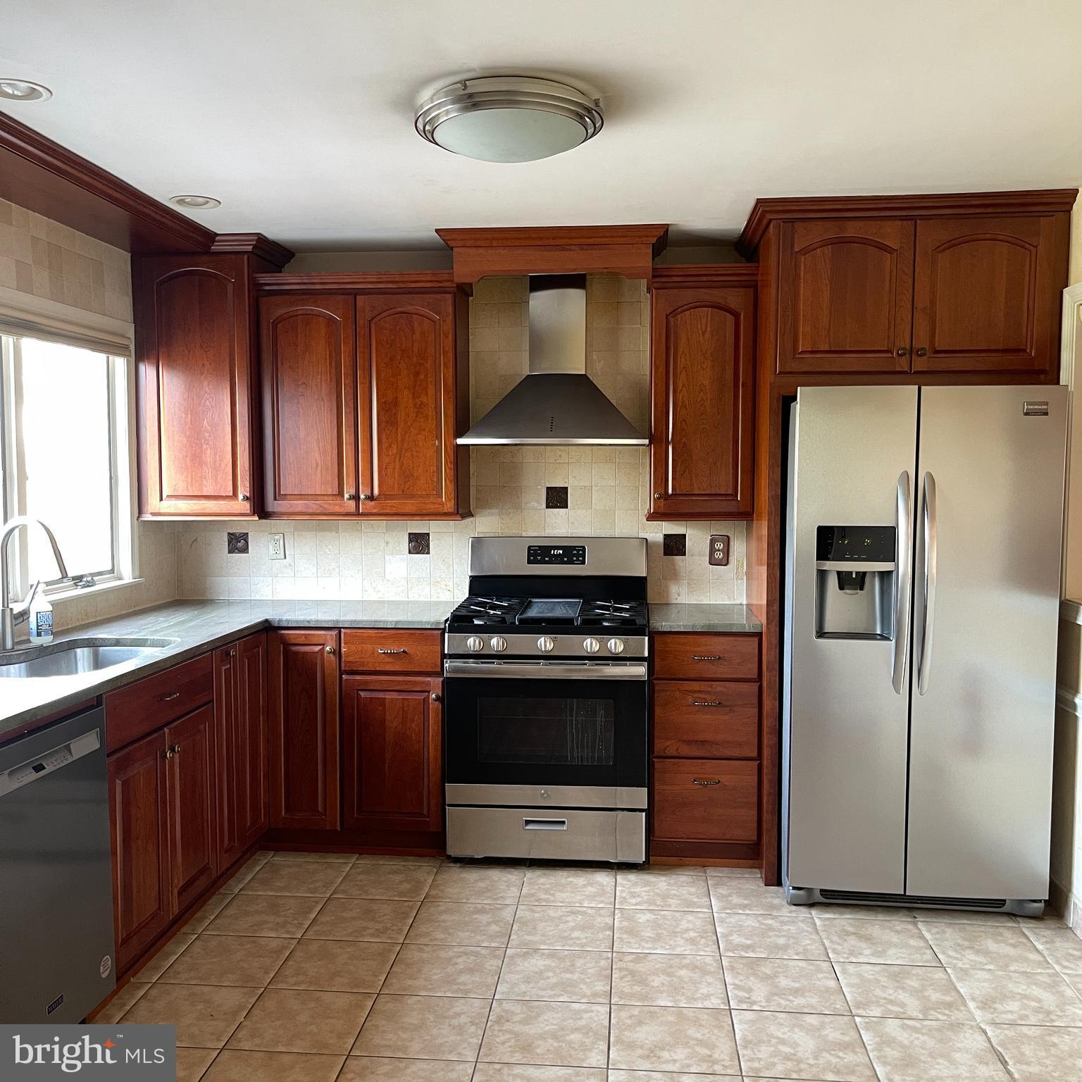 19 Hanover Court Princeton, NJ 08540 - Photo 5 of 25 a kitchen with stainless steel appliances granite countertop a stove refrigerator and cabinets