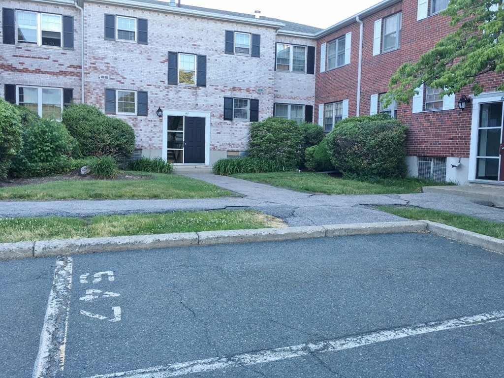157 Lake Shore Road, Unit 2 Boston, MA 02135 - Photo 12 of 28 a view of a brick building next to a yard