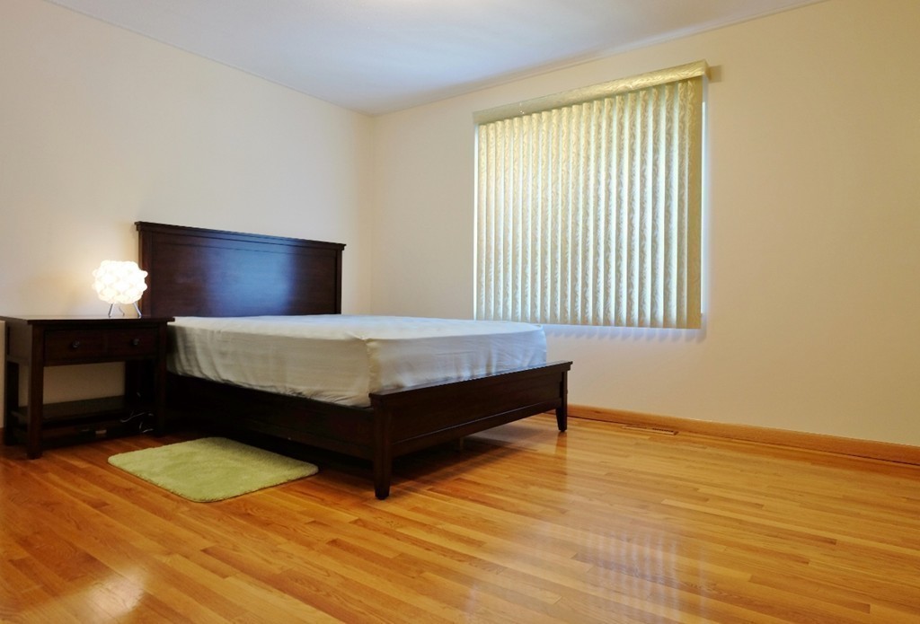 157 Lake Shore Road, Unit 2 Boston, MA 02135 - Photo 22 of 28 a bedroom with a bed and a night stand