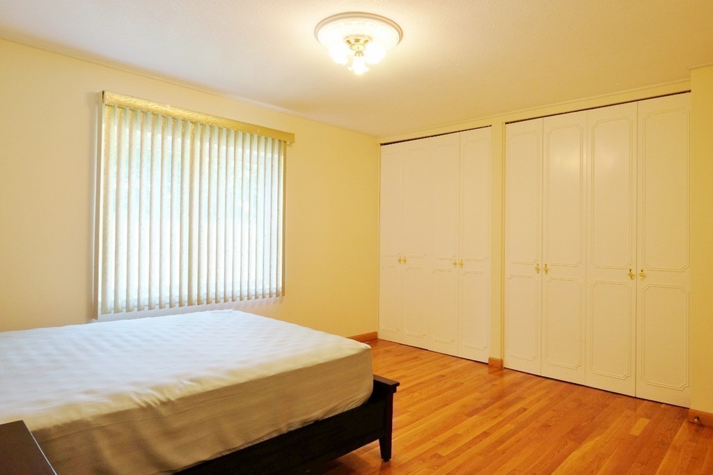 157 Lake Shore Road, Unit 2 Boston, MA 02135 - Photo 23 of 28 a bedroom with a bed and a window