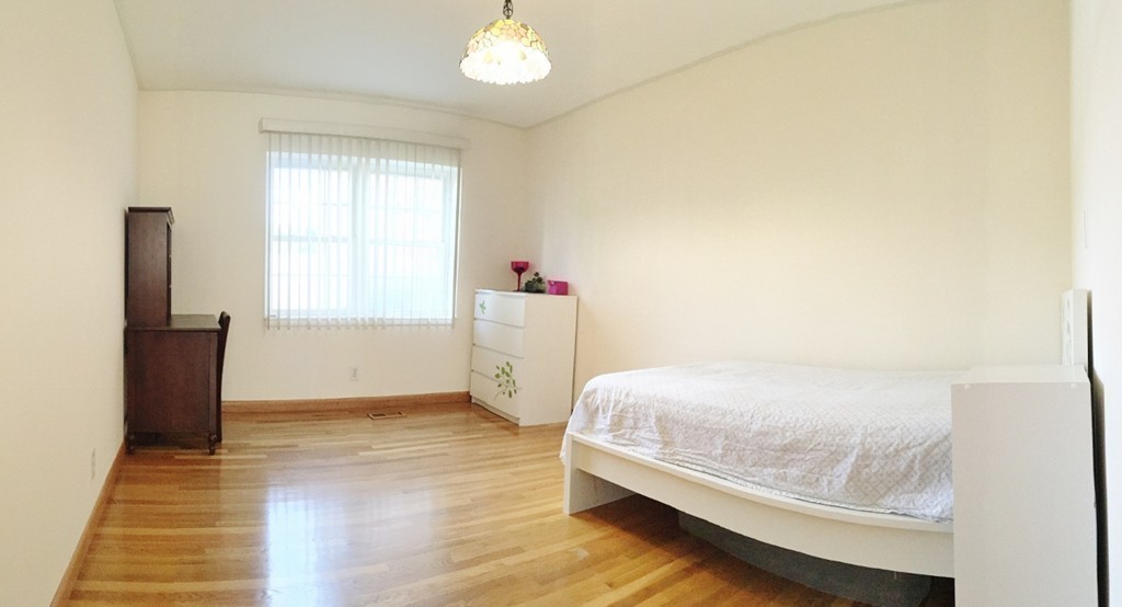 157 Lake Shore Road, Unit 2 Boston, MA 02135 - Photo 27 of 28 a bedroom with a bed and a window