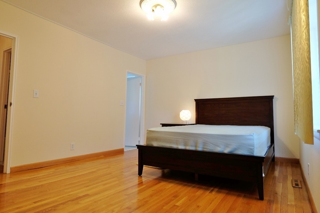157 Lake Shore Road, Unit 2 Boston, MA 02135 - Photo 5 of 28 a room with table and chair