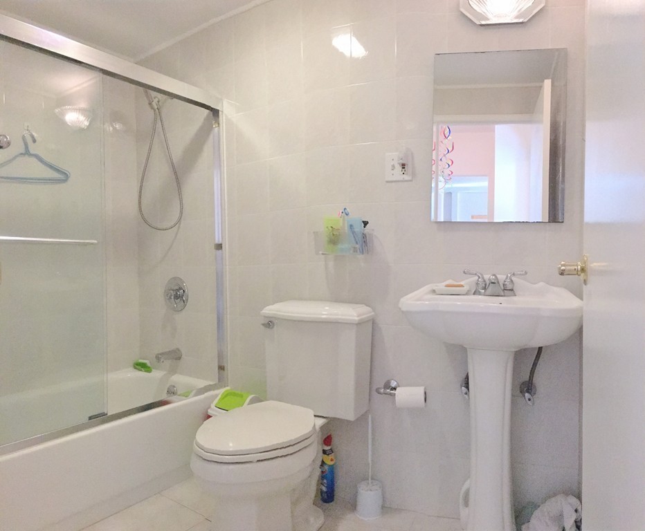 157 Lake Shore Road, Unit 2 Boston, MA 02135 - Photo 8 of 28 a bathroom with a sink toilet and shower
