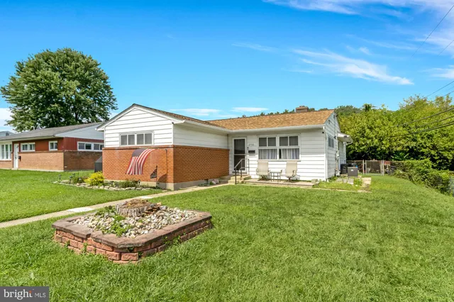 a front view of a house with a yard table and chairs