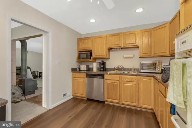 a kitchen with stainless steel appliances granite countertop a refrigerator and a stove top oven