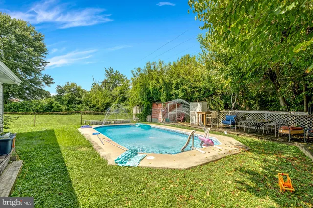 a view of a backyard with swimming pool