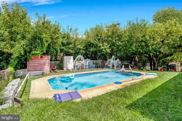 a view of a backyard with swimming pool