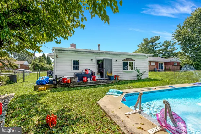 a view of a house with backyard sitting area and garden