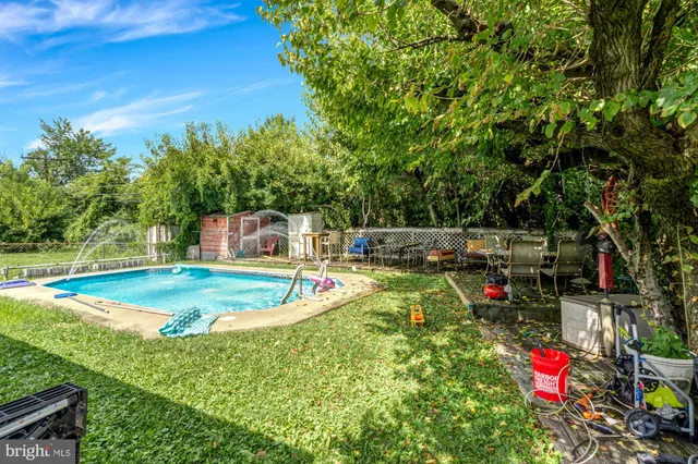 a view of a backyard with swimming pool