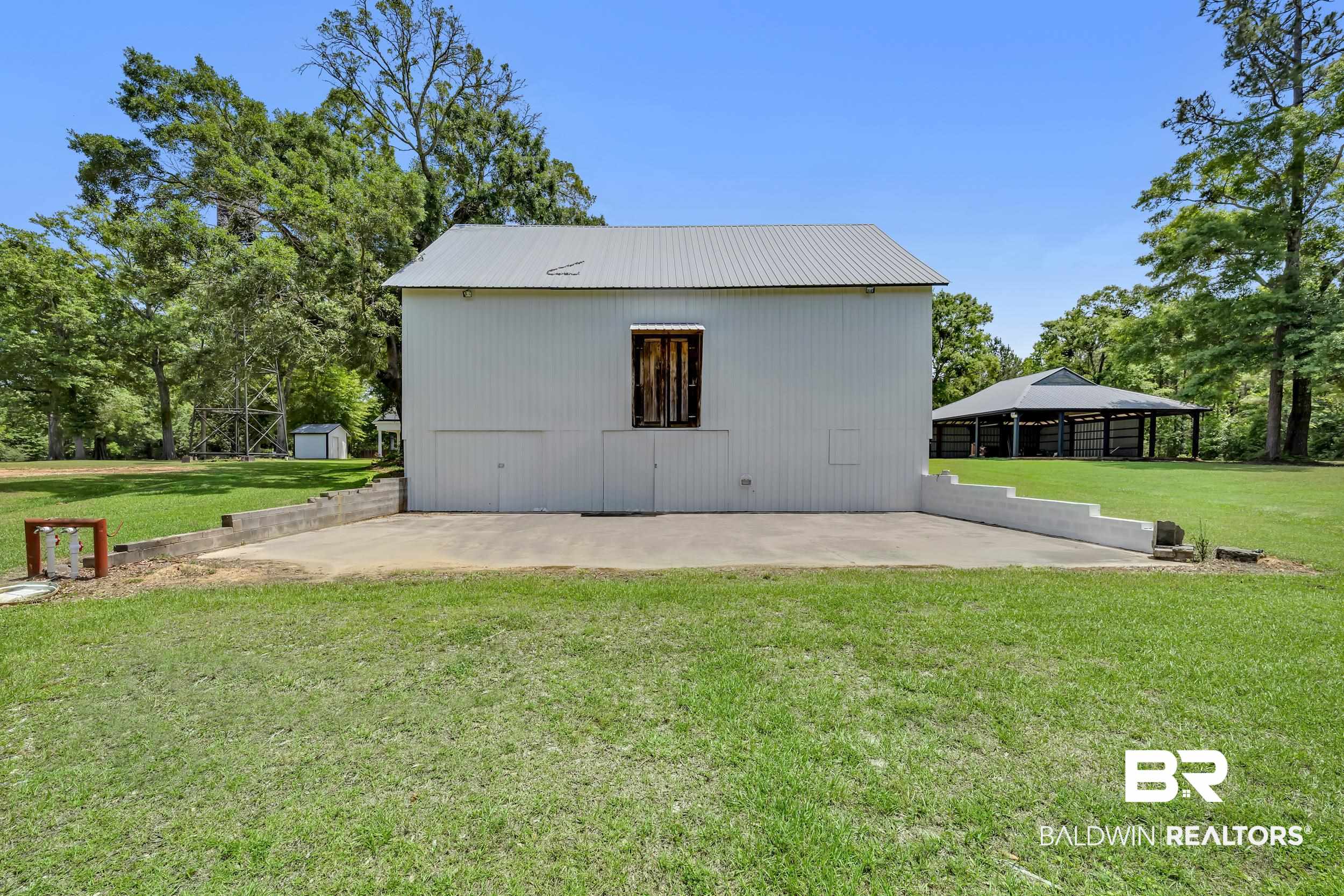 43199 Pine Grove Road Bay Minette, AL 36507 - Photo 22 of 71 White-sided outbuilding with a metal roof and concrete pad