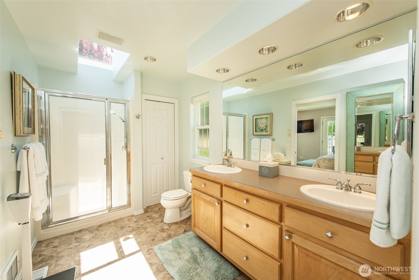 170 Donaper Road Sequim, WA 98382 - Photo 19 of 40 a spacious bathroom with a shower sink and mirror