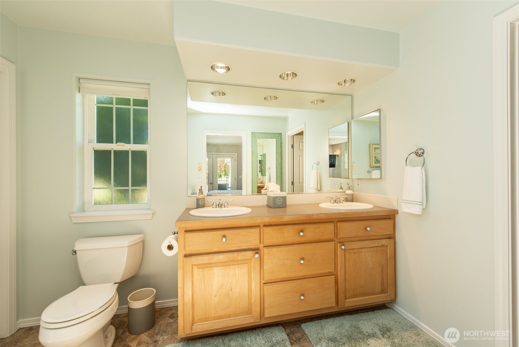 170 Donaper Road Sequim, WA 98382 - Photo 20 of 40 a spacious bathroom with a toilet sink and mirror
