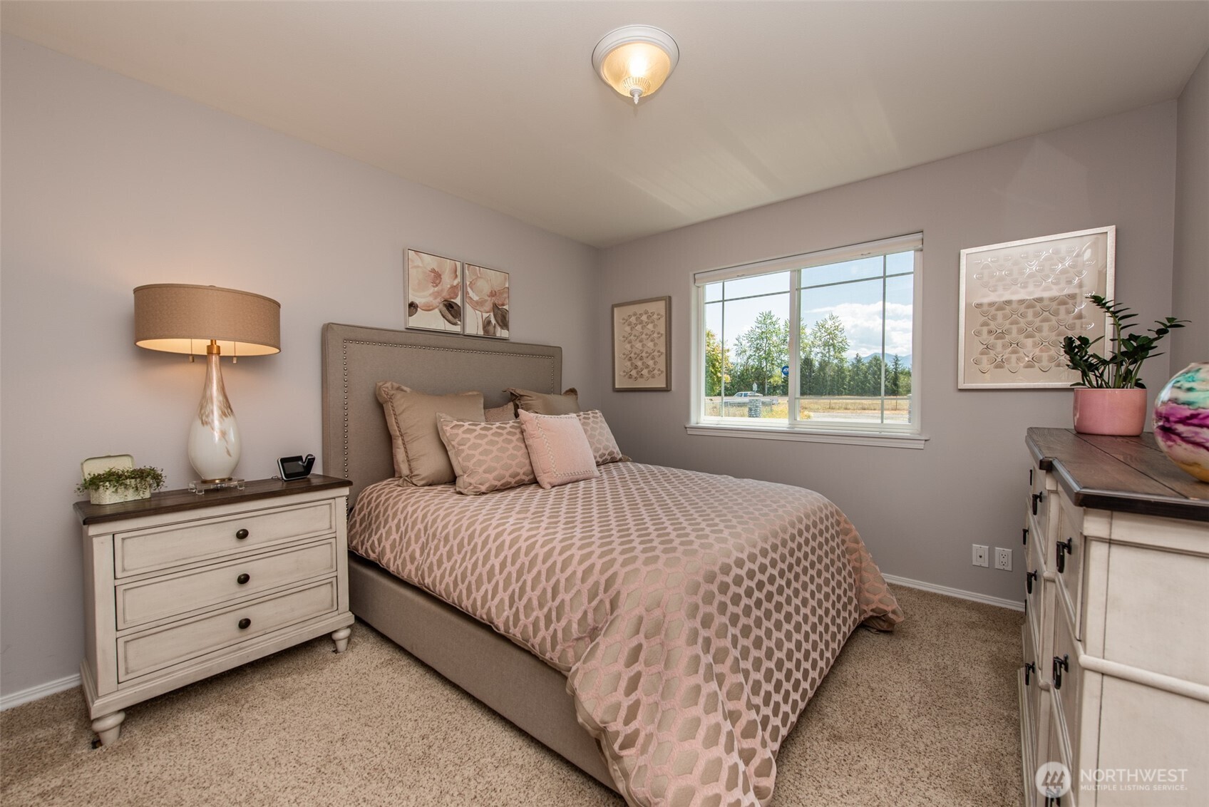 170 Donaper Road Sequim, WA 98382 - Photo 23 of 40 a bedroom with a bed and a lamp on dresser