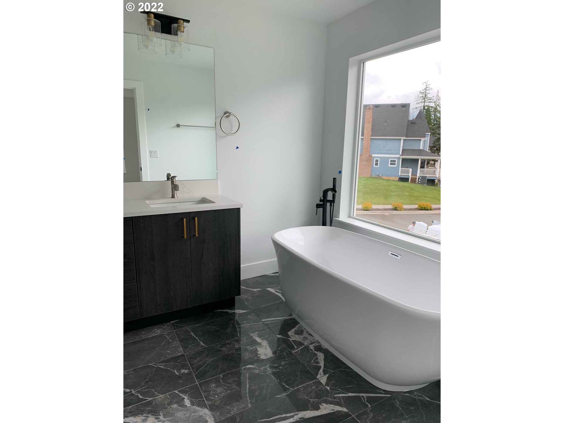 1829 North 4th Way Ridgefield, WA 98642 - Photo 14 of 17 a bathroom with a bathtub sink vanity and toilet