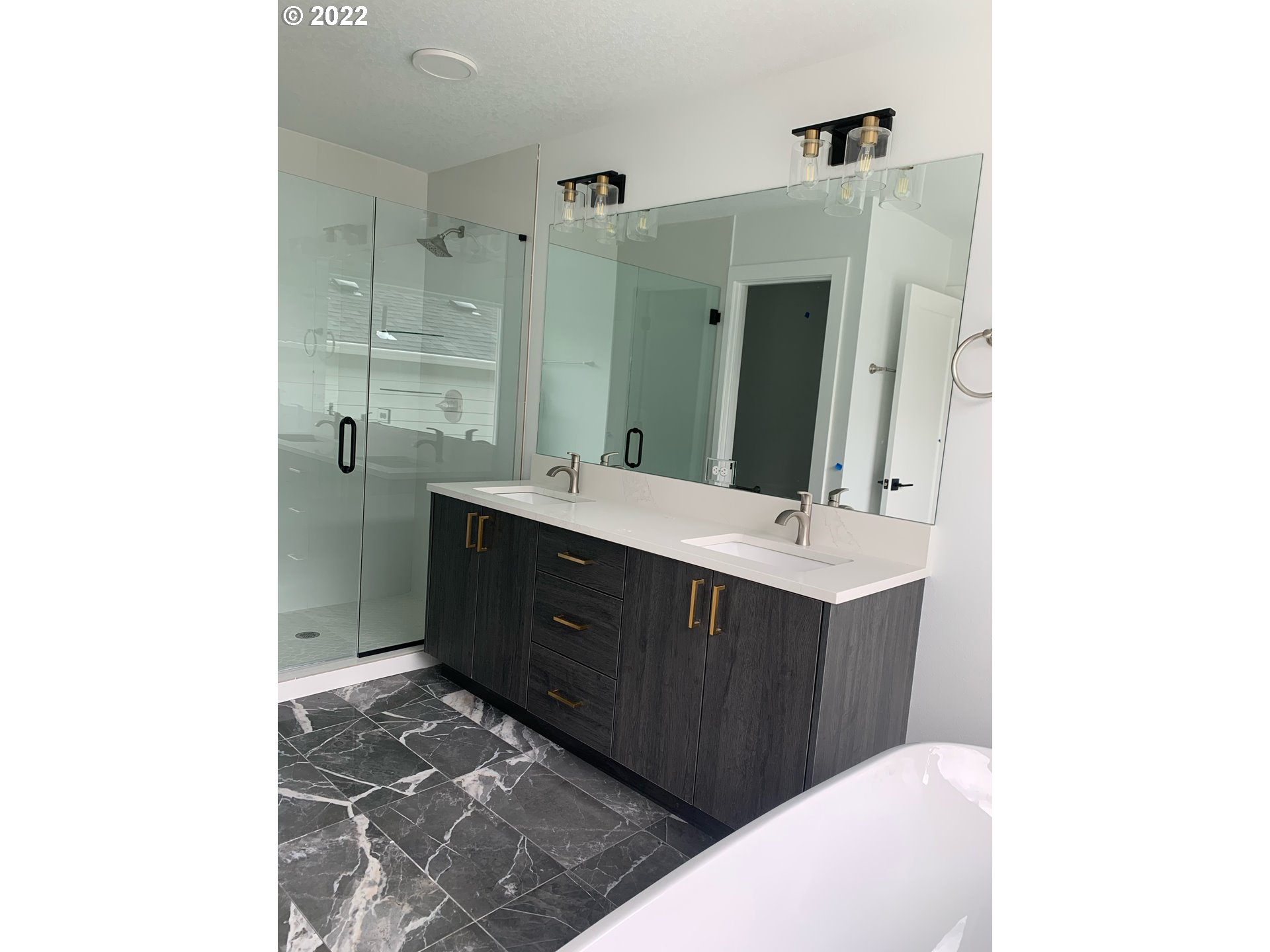 1829 North 4th Way Ridgefield, WA 98642 - Photo 15 of 17 a bathroom with a sink vanity and a mirror