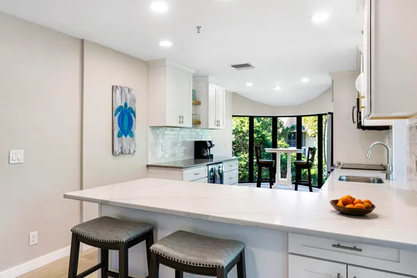 a kitchen with stainless steel appliances white cabinets and a stove a oven with white countertops