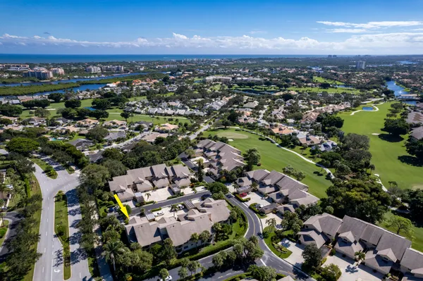 an aerial view of multiple houses with a yard