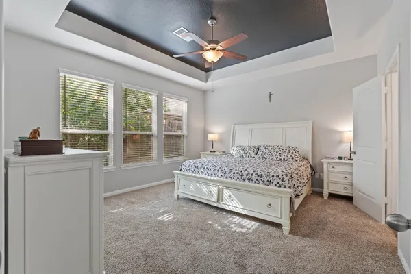 a spacious bedroom with a bed and a large window
