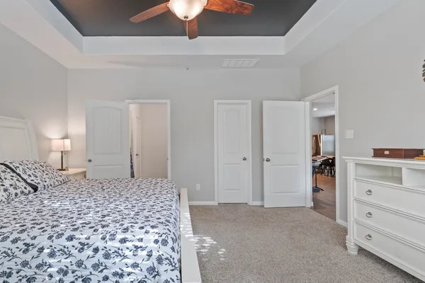 a large bedroom with a bed and a cabinets