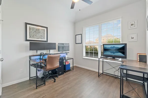 a view of a workspace with furniture and a window