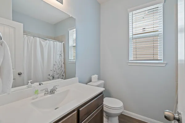 a bathroom with a sink toilet and a mirror