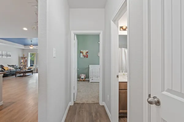 a view of a hallway with livingroom and furniture