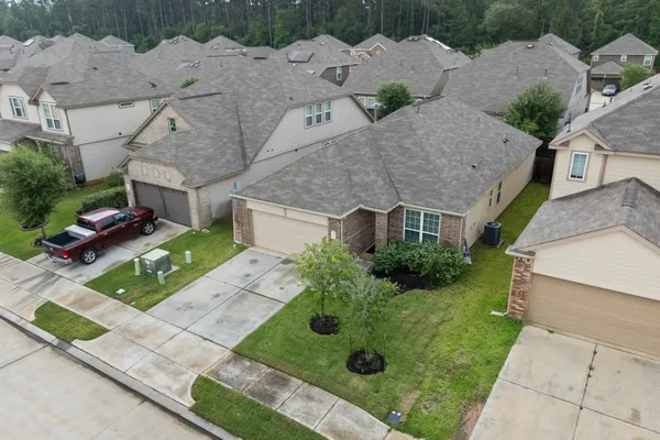 an aerial view of multiple houses with a yard
