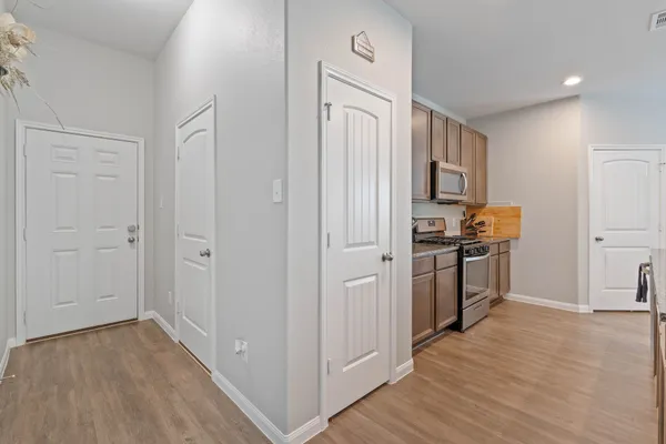 a view of kitchen with refrigerator microwave and stove