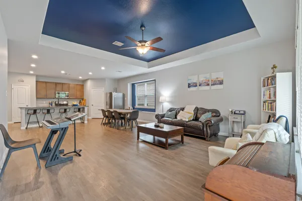 a living room with furniture and a wooden floor