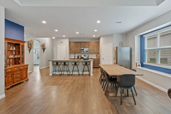 a dining room with furniture and wooden floor