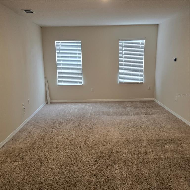814 Sun Burst Road Winter Haven, FL 33880 - Photo 20 of 48 an empty room with windows
