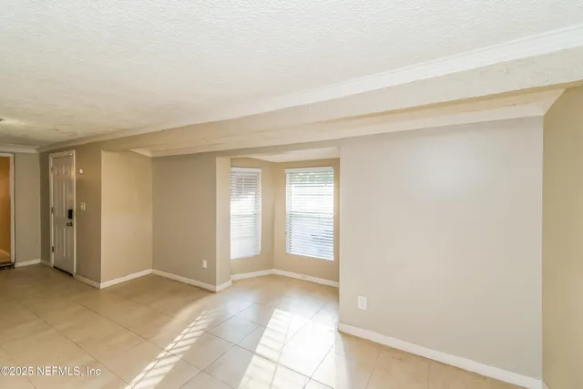 a view of a room with an empty space and a window