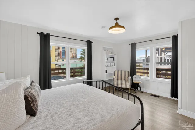 a bedroom with a bed and a large window