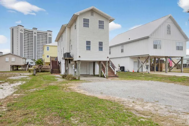 a view of a house with a yard and a car parked in front of it