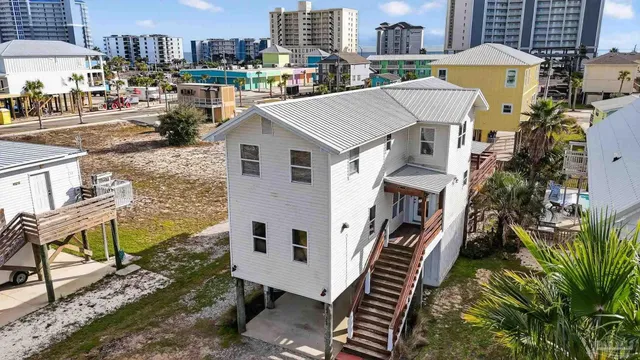 an aerial view of a house with a yard sitting space and barbeque oven