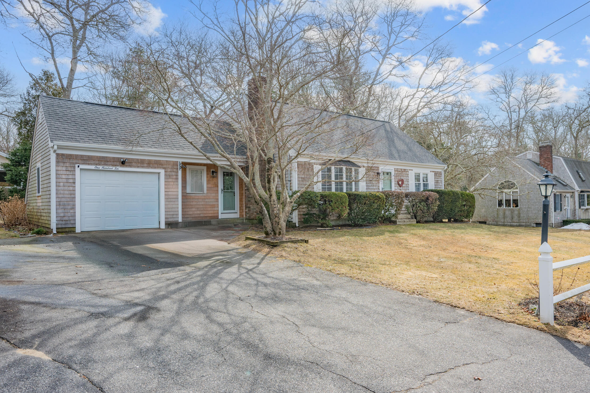 110 Fuller Road Centerville, MA 02632 - Photo 2 of 23 a view of large house with a yard and garage