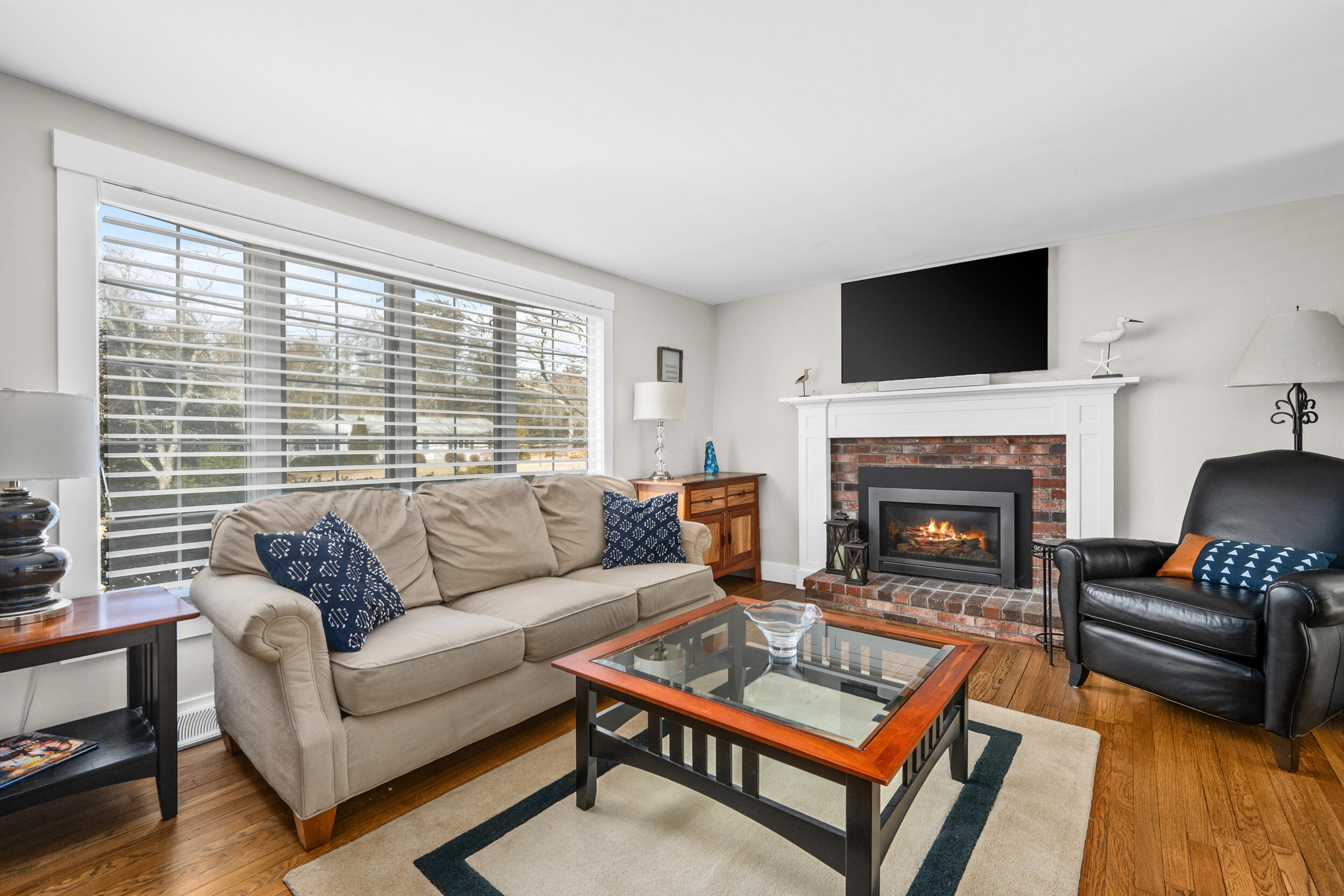 110 Fuller Road Centerville, MA 02632 - Photo 8 of 23 a living room with furniture a flat screen tv and a fireplace