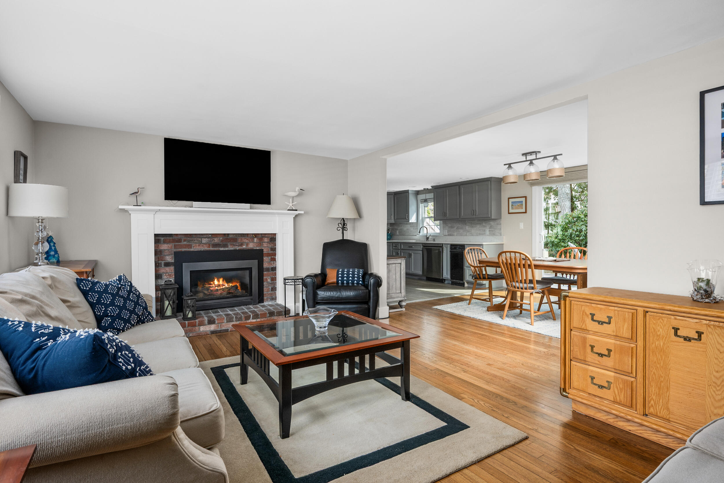 110 Fuller Road Centerville, MA 02632 - Photo 9 of 23 a living room with furniture a flat screen tv and a fireplace