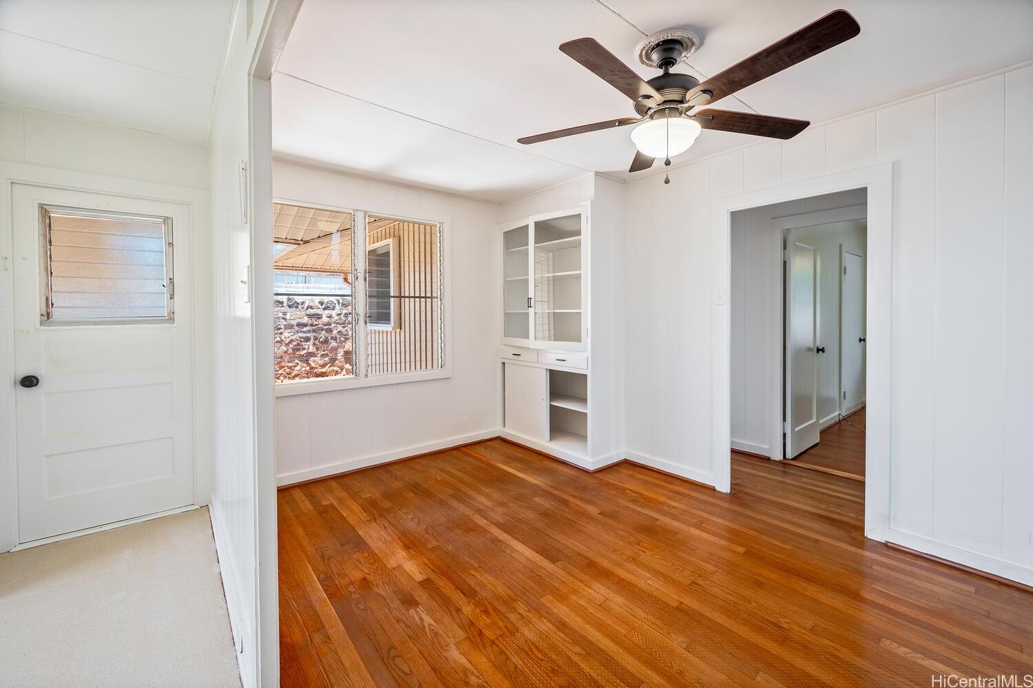 930 16th Avenue Honolulu, HI 96816 - Photo 11 of 24 wooden floor in an empty room with a window