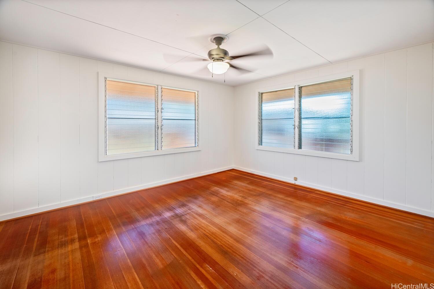 930 16th Avenue Honolulu, HI 96816 - Photo 12 of 24 wooden floor in an empty room with a window