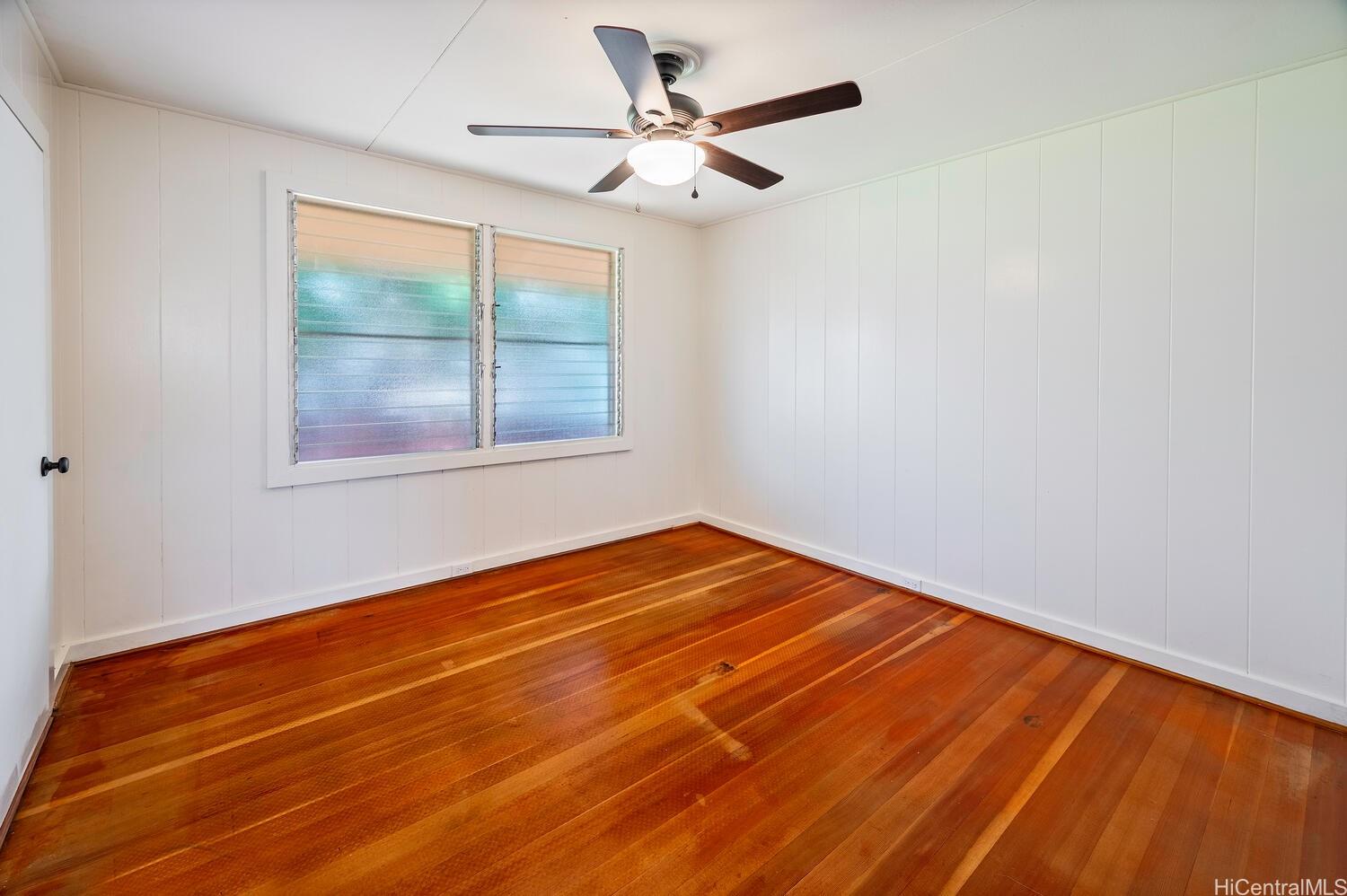 930 16th Avenue Honolulu, HI 96816 - Photo 13 of 24 an empty room with wooden floor and windows