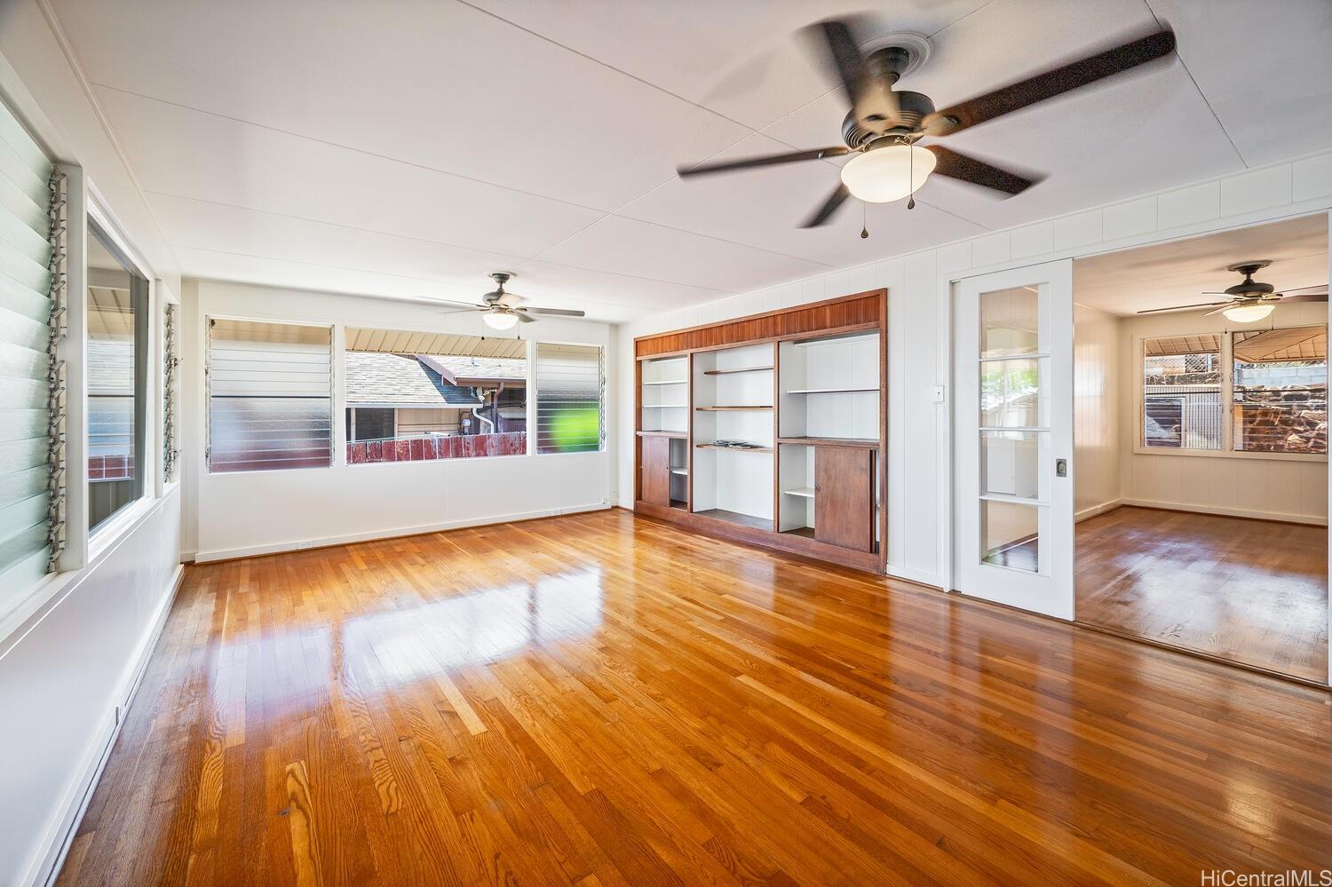 930 16th Avenue Honolulu, HI 96816 - Photo 5 of 24 a view of an empty room with wooden floor and a window