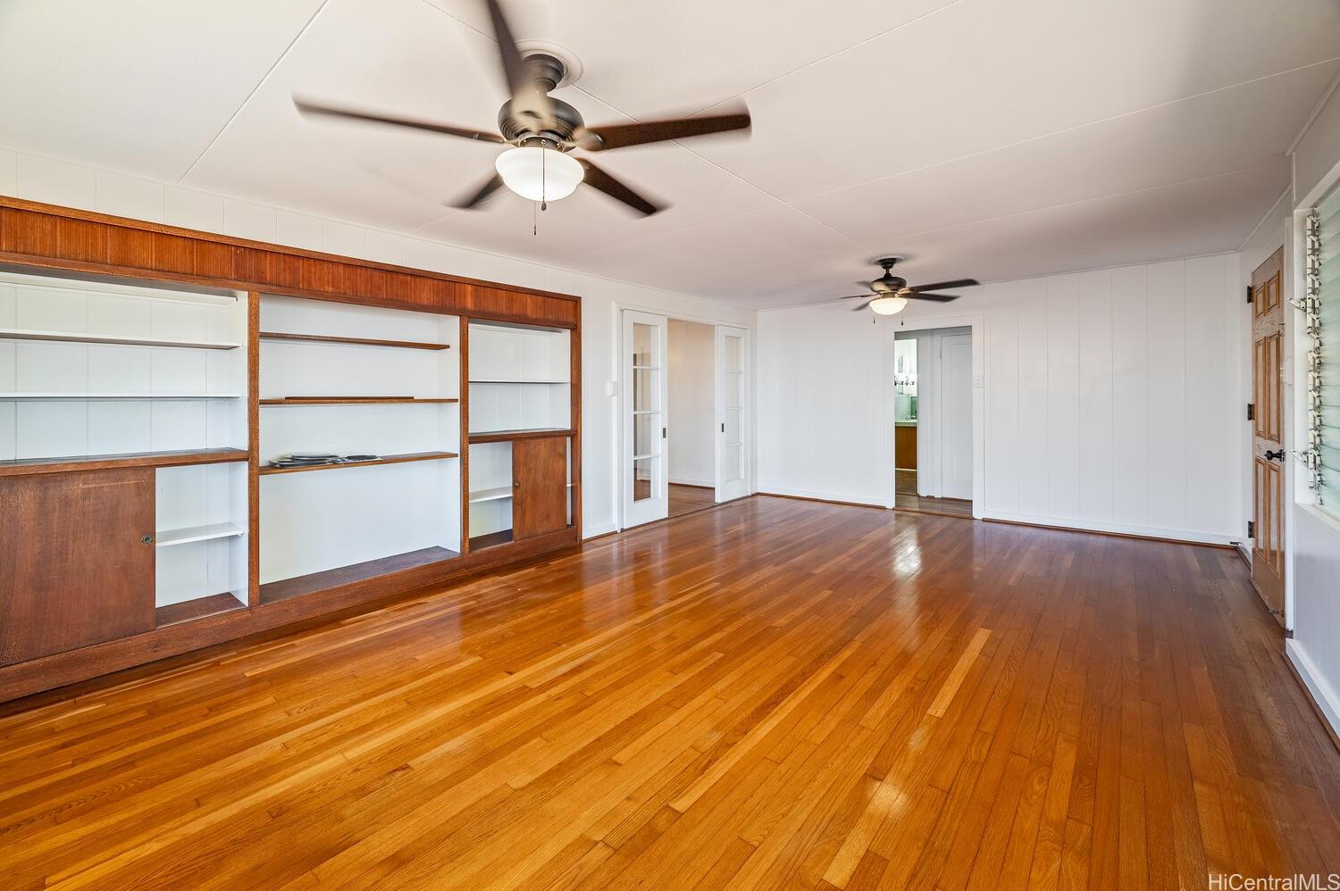 930 16th Avenue Honolulu, HI 96816 - Photo 6 of 24 a view of empty room with wooden floor and fan