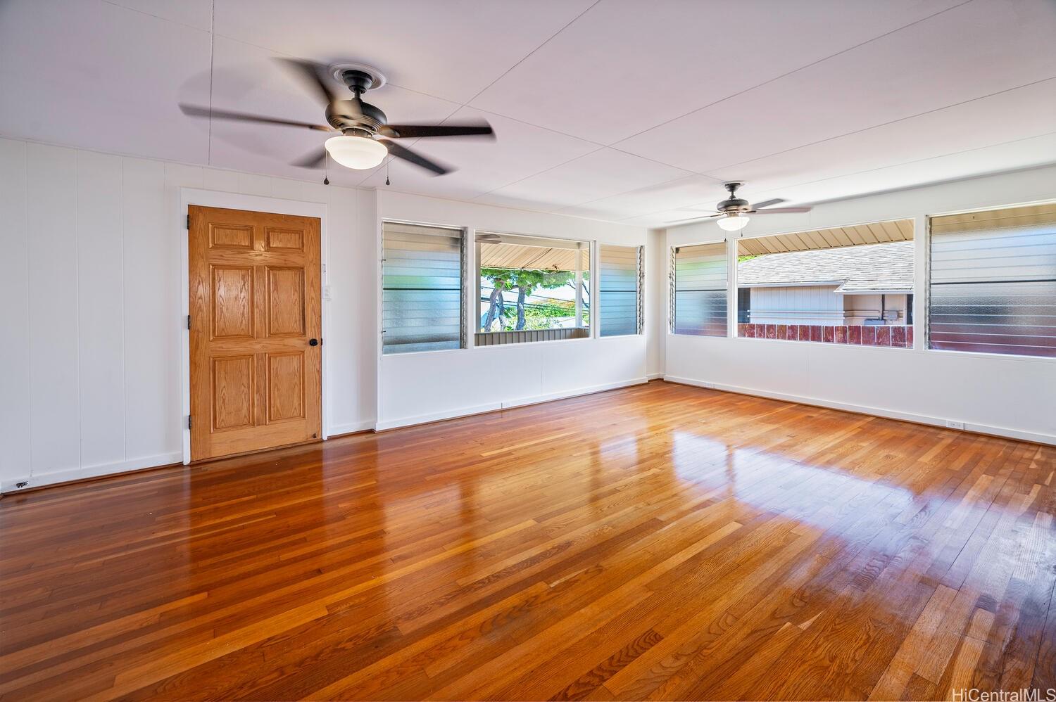 930 16th Avenue Honolulu, HI 96816 - Photo 7 of 24 a view of empty room with wooden floor and fan